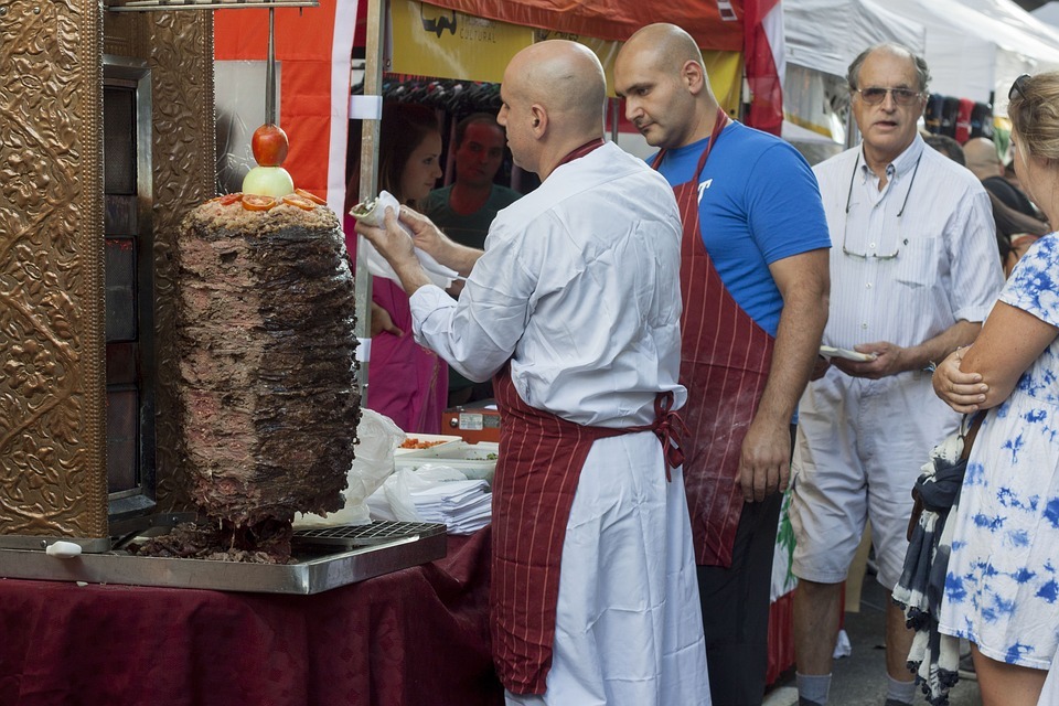 people in front of a shawarma stand