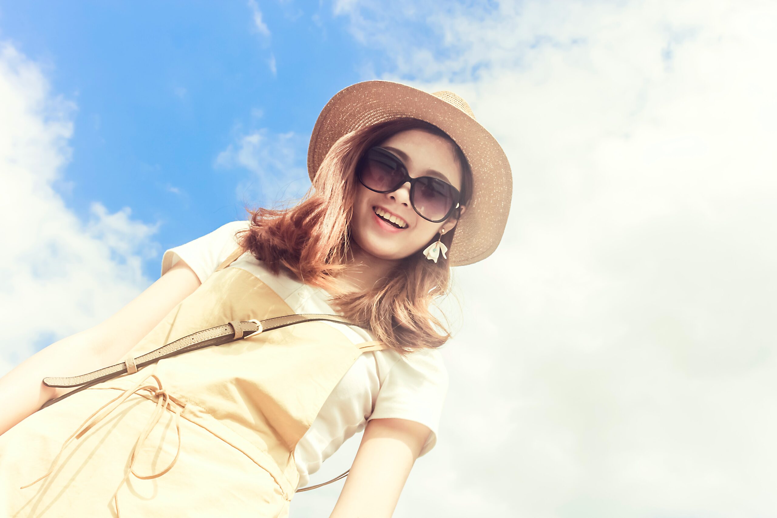woman-wearing-dress-smiling-taking-for-picture-under-cloudy-skies