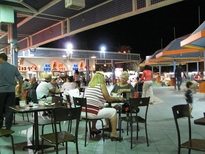 people dining and strolling outside at night