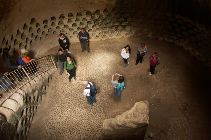 people in a cave with columbarium