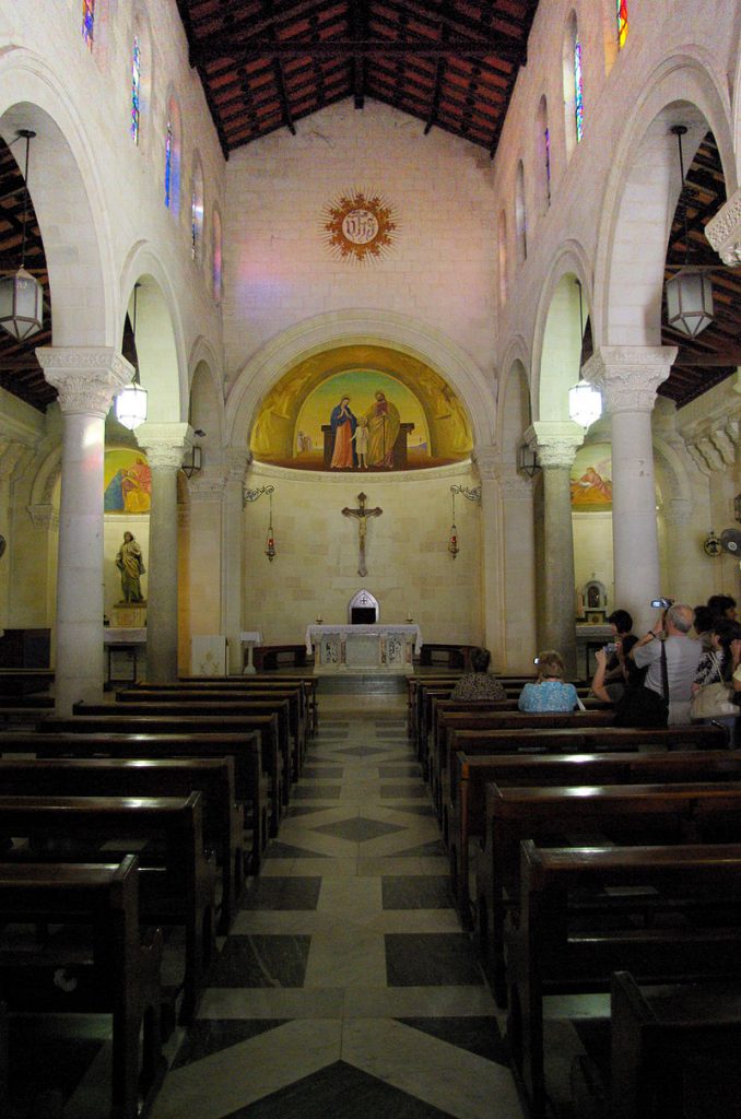 church interior with the altar on the center and pews flanking the aisle