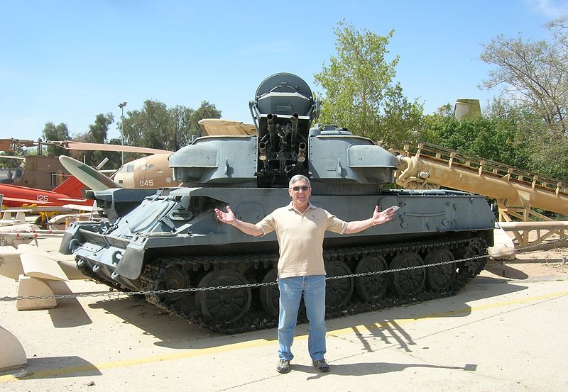Man in front of a tank