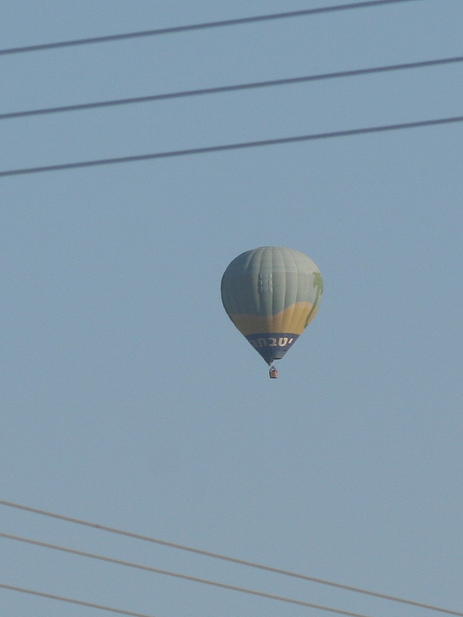 hot air balloon floating in the blue sky