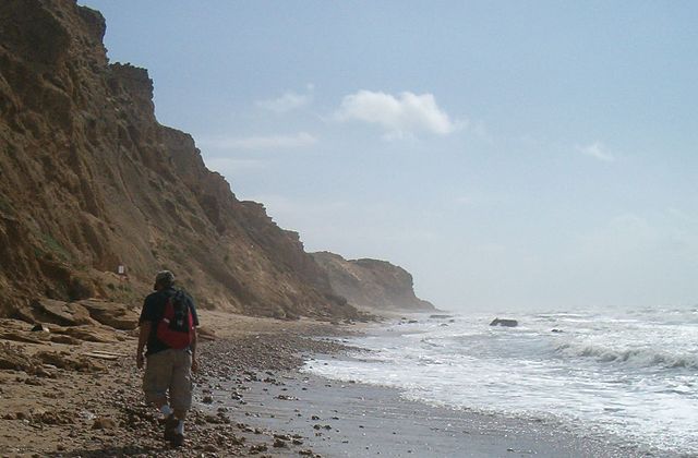 A man hiking along the coast of Mediterranean, between Netanya and Herzliya, Israel