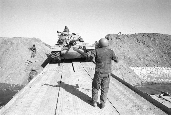black and white photo of Israeli tanks crossing the Suez Canal