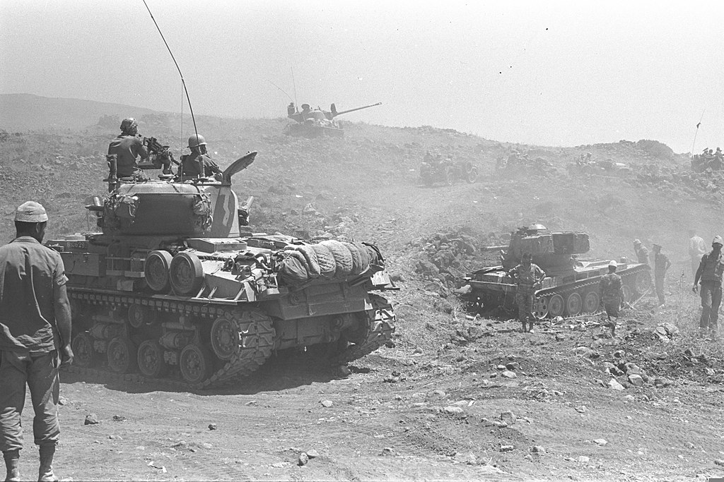 black and white picture of Israeli tanks and troops advancing on the Golan Heights, 1967