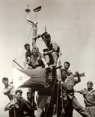 a black-and-white photo of the Israeli naval personnel celebrate their victory after an engagement with Egyptian naval forces near Rumani